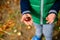 Little boy play with chestnuts in autumn day