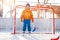 Little boy play hockey standing in gates
