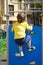 Little boy at playground plays sports. Fitness motivation