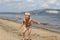 Little boy playing on the beach near the river