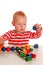 Little boy playing with beads