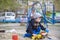 Little boy playing with children excavator in the sandbox