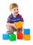 Little boy playing with colorful cubes