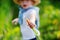 Little boy playing in domestic garden in summer day