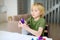 Little boy playing dough at home during coronavirus quarantine. Child is molding from plasticine model virus covid-19.