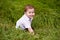 Little boy playing in green grass. world children`s day content