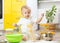 Little boy playing with kitchenware and foodstuffs