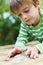 Little boy playing looking at sunflower seeds