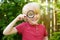 Little boy playing with magnifying glass. Little boy carefully looking at you with magnifier. Activity for inquisitive child