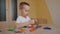 Little boy playing molding colorful plasticine, making toys sculpting playdough