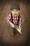 Little boy playing outdoor with a toy wooden gun