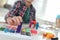 Little boy playing with plasticine at table, closeup. Creative hobby