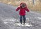 Little Boy Playing In Rain Puddle