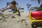 Little boy playing with sand and beach toys