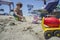 Little boy playing with sand and beach toys