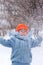 Little boy playing snowballs