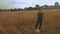 Little boy playing soccer in the field. Child running through meadow with a ball. Countryside and forest