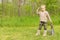 Little boy playing at soldiers standing saluting