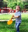 Little boy playing tennis Happy cheerful boy holding a racket st