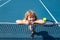 Little boy playing tennis. Sport kids, thumbs up, winner. Child with tennis racket on tennis court. Training for young