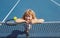 Little boy playing tennis. Sport kids, thumbs up, winner. Child with tennis racket on tennis court. Training for young