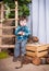 Little boy is playing with the tools of a carpenter.