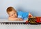 Little boy playing with a toy locomotive