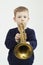 Little boy playing trumpet.music child.musical instrument