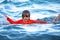 Little boy playing with Waves on blue sea. Kid swimming having fun and jumping in the waves of the sea.