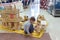 Little boy playing wooden constructor in the pavilion of the exhibition hall at the popular traditional fair of handmade folk arts