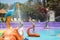 Little boy in the pool with fountains splashing