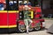 Little boy posing against the background of a steam locomotive in an amusement park