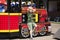 Little boy posing against the background of a steam locomotive in an amusement park