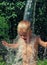 Little boy is poured with cold water from bucket. Kids water games on hot day in backyard. Hardening for health. Strengthen your