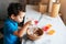 Little boy pouring muffin mixture into a cup