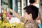 Little boy pouring water over Buddha statues