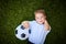 Little Boy practising soccer outdoors