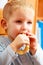 Little boy preschooler eating apple peel.