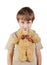 Little boy presses bear-toy by his chin to chest