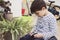 Little boy pruning flower pot at home as a gardener