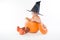 Little boy in a pumpking in witch hat holding candy