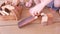 Little boy pushes a wooden car from the slide.