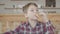 Little boy putting french fries in mouth in cafe