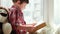 Little boy reading book of tales with his toy, smart kid closeup portrait, small child reading book