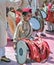 Little boy with red cap beating huge traditional dhol during Ganesh festival