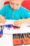 Little boy repairing toy train