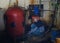 Little boy repairs water boilers in basement