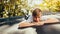 Little boy resting on trampoline after playing