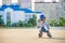 Little boy riding on rollers in the summer in the Park. Happy child in helmet learning to skate