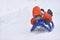 Little boy riding on snow slides in winter time